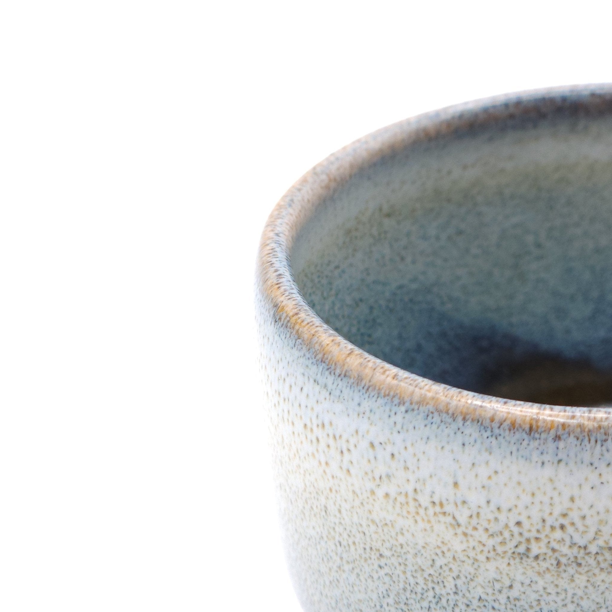 Authentic Japanese pottery teacup with tree decoration. blue and white color. (side detail view 1).