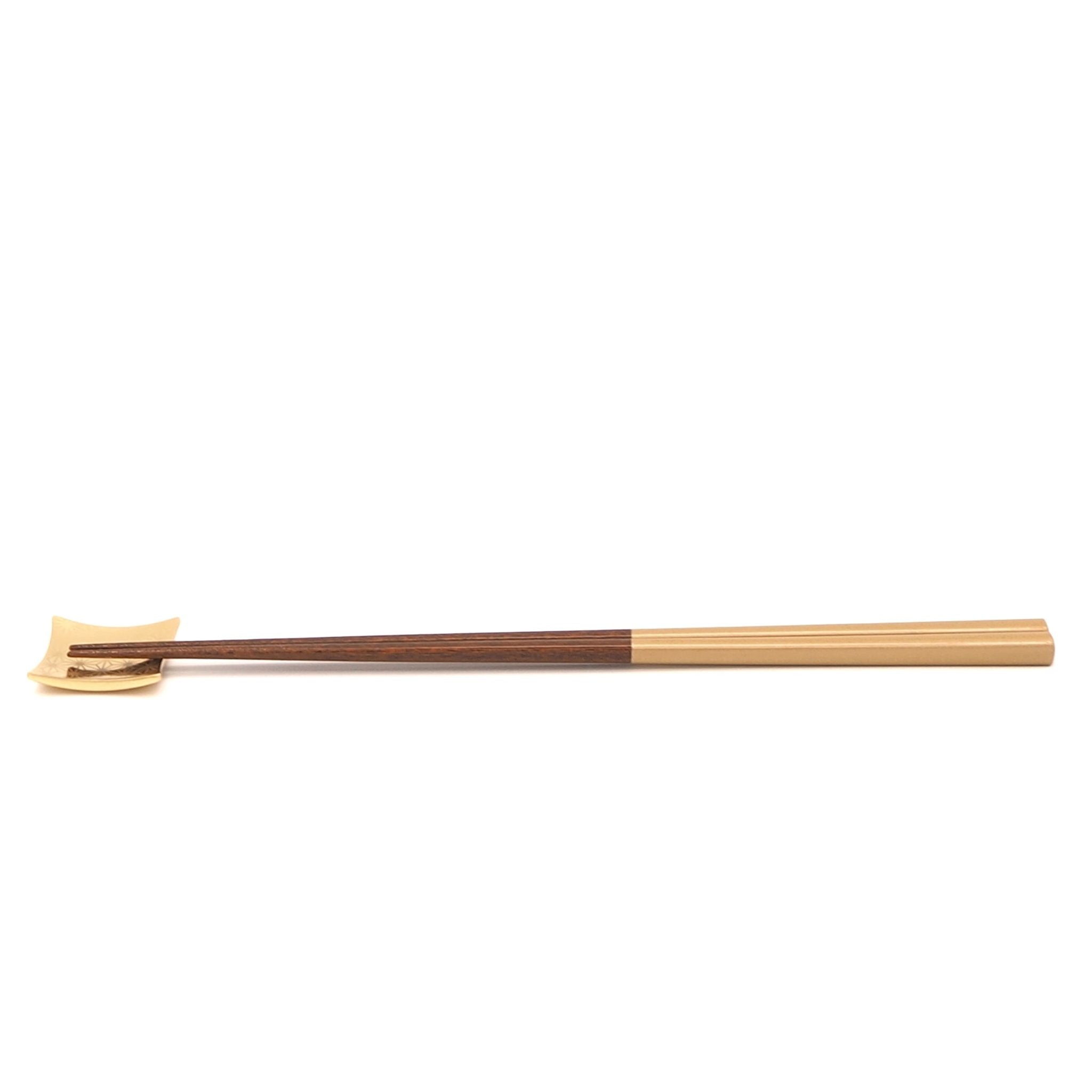 Side view of a golden Japanese wooden chopsticks on rest