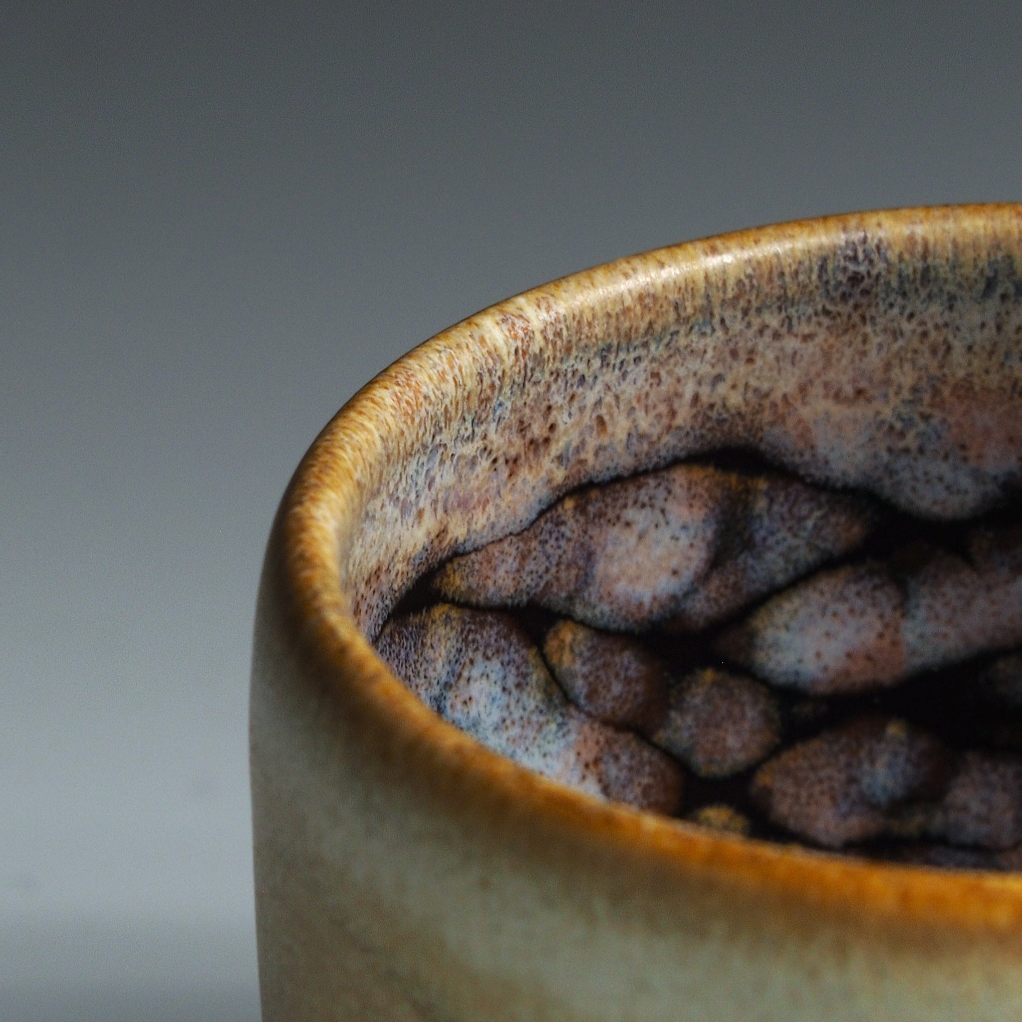 Close-up of a the interior of a Japanese ceramic cup with sakura decorations.