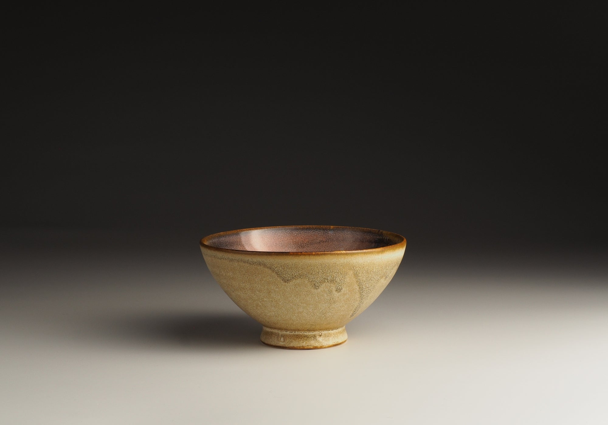 A Japanese Ceramic rice bowl with cherry blossom motif on a gradient background. Tsukushi