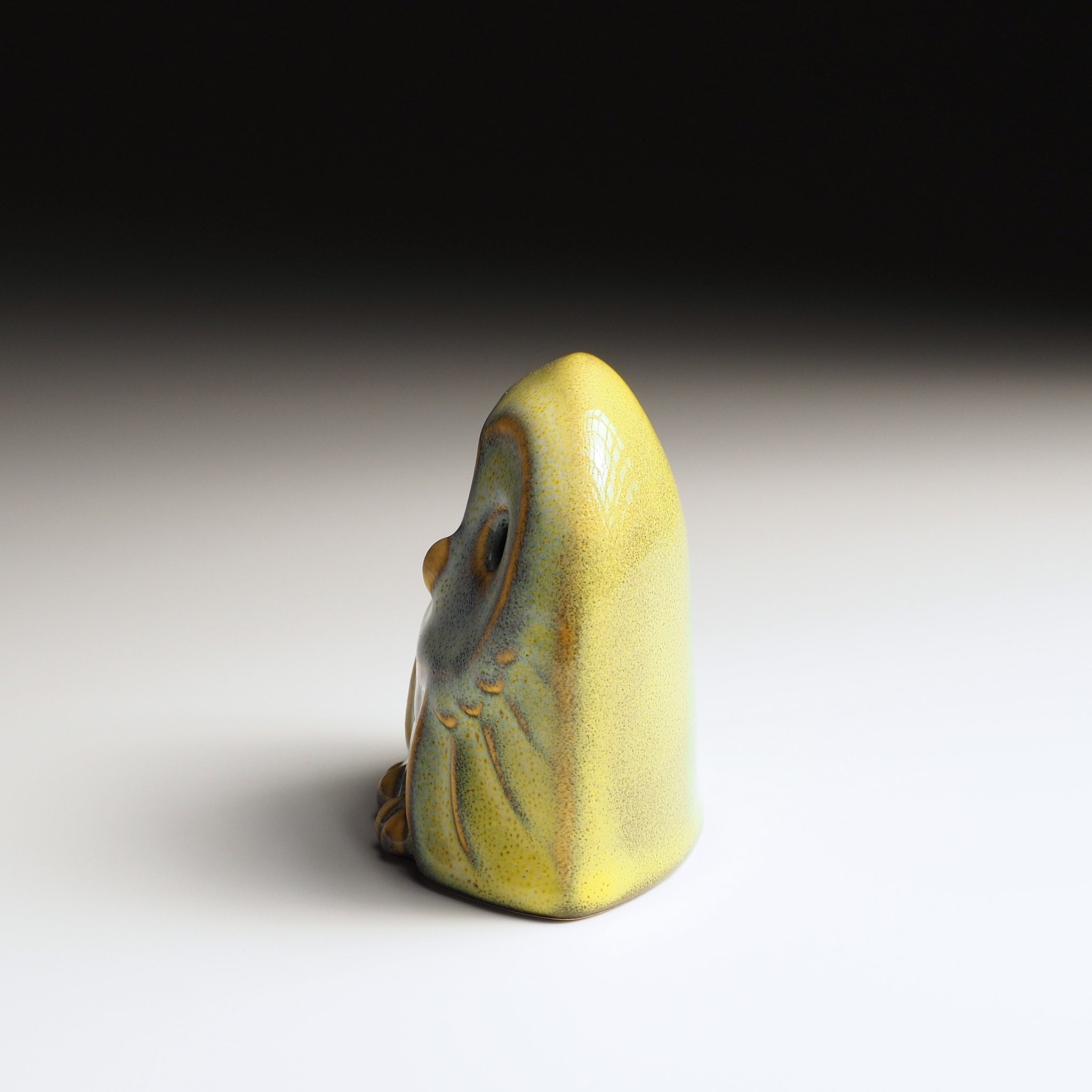 Left view of Engifuku owl figurine by Kazuhiro Kojima, blue speckled ceramic glaze, golden accents, hollow eyes, gradient background.