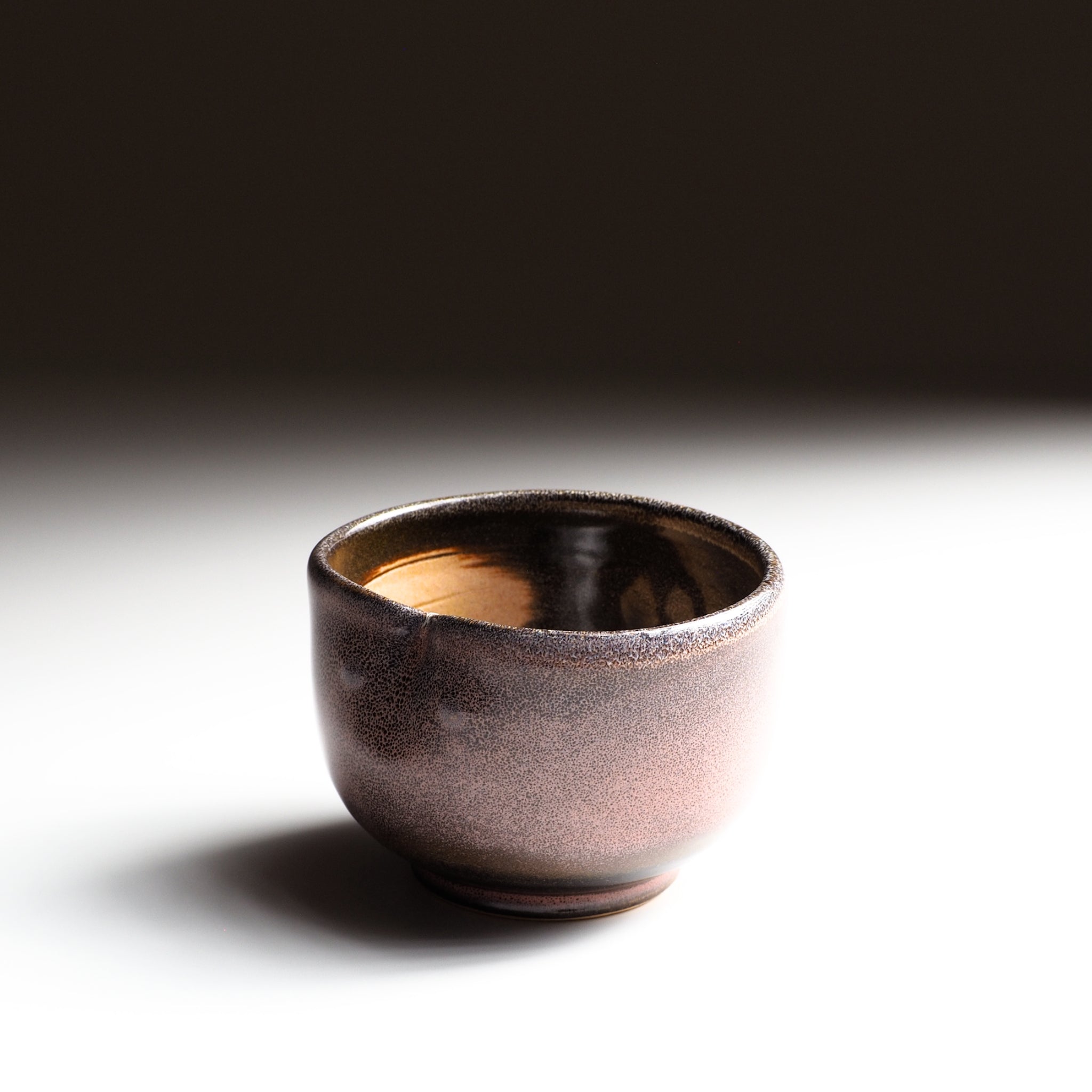 Japanese ceramic teacup Fukuro with a owl motif on a gradient background