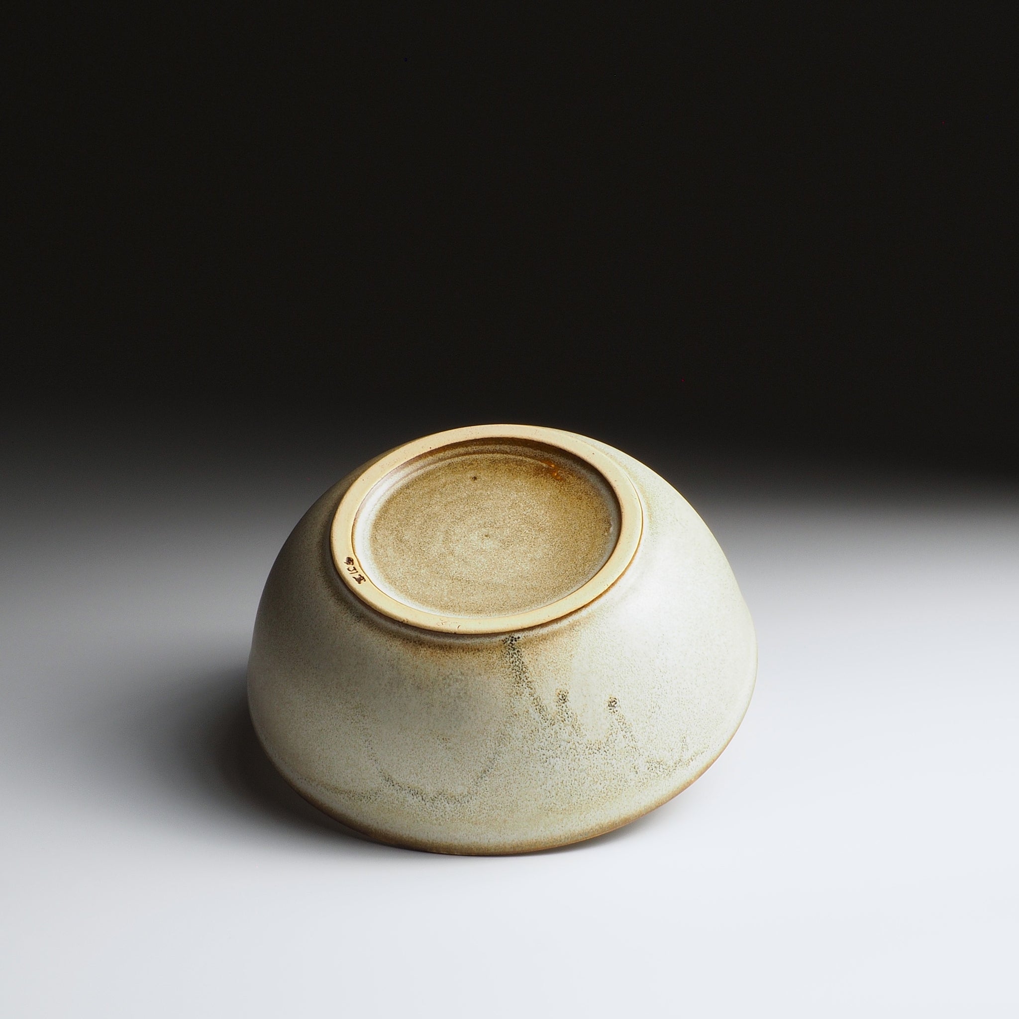 Harukaze Japanese green salad bowl by K.Kojima. Foot view on gradient background.