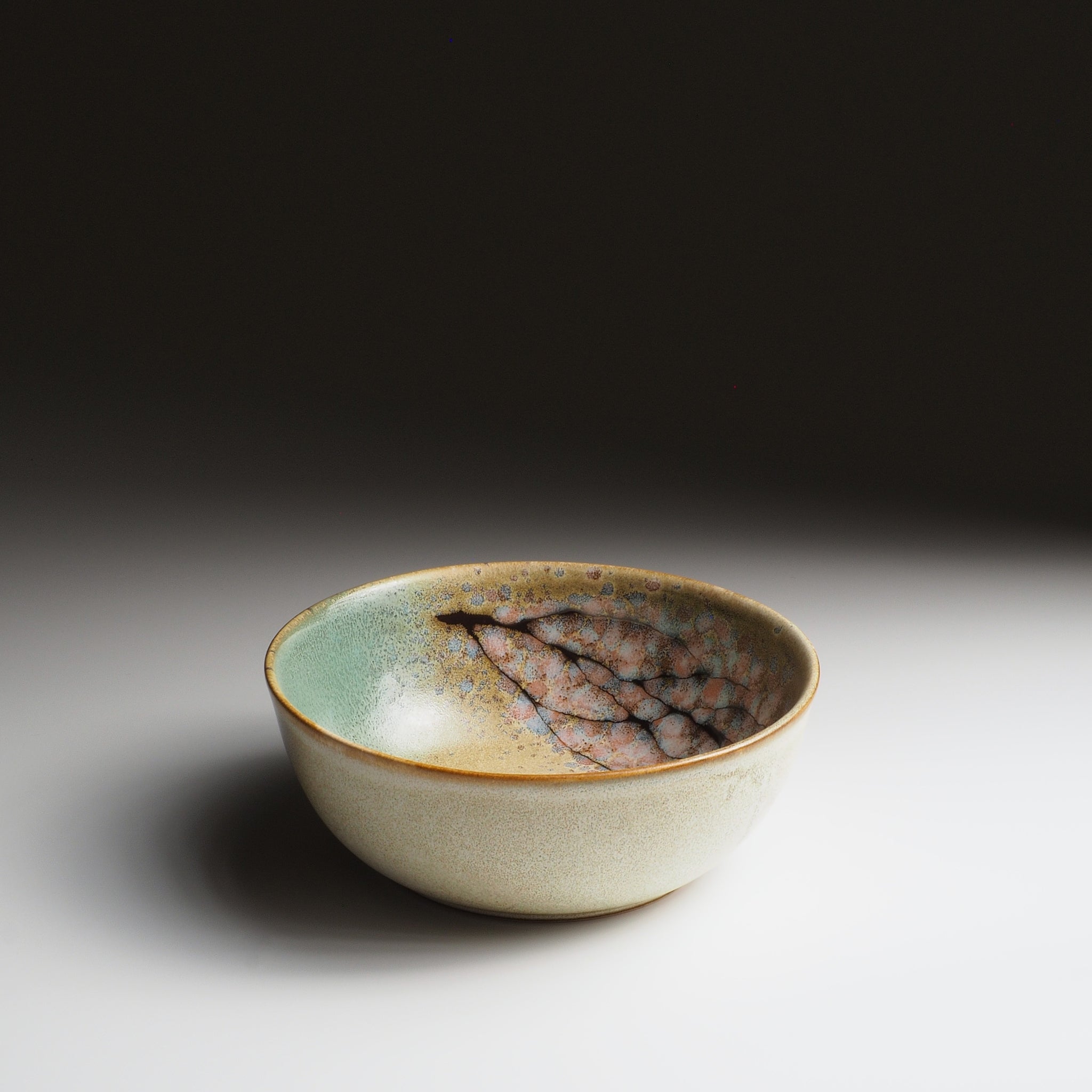 Harukaze Japanese green salad bowl by K.Kojima. 3/4 front view on gradient background.