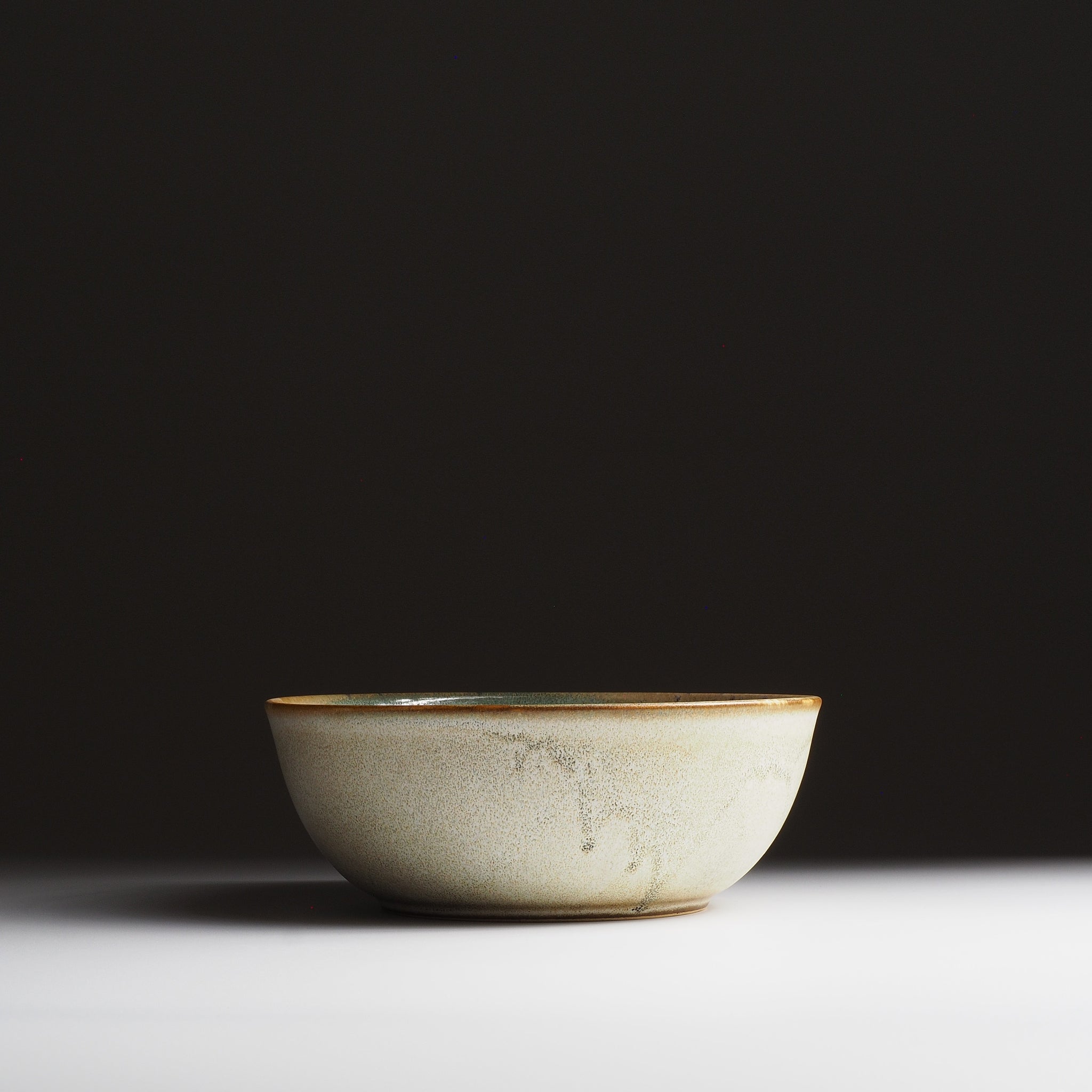 Harukaze Japanese green salad bowl by K.Kojima. Full frontal view on gradient background.