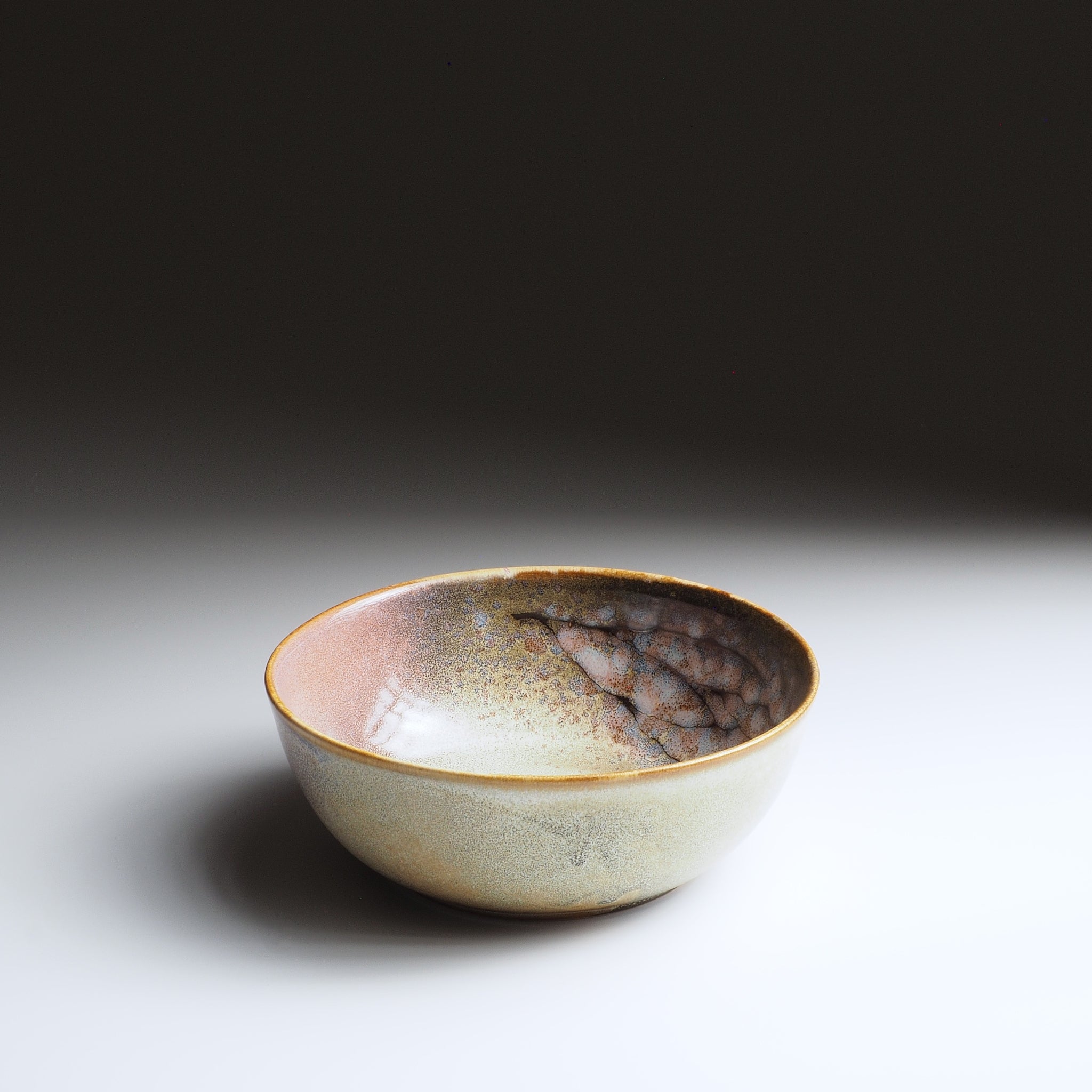 Harukaze Pink Cherry Blossoms salad bowl by Kazuhiro Kojima, 3/4 view on a faded background.