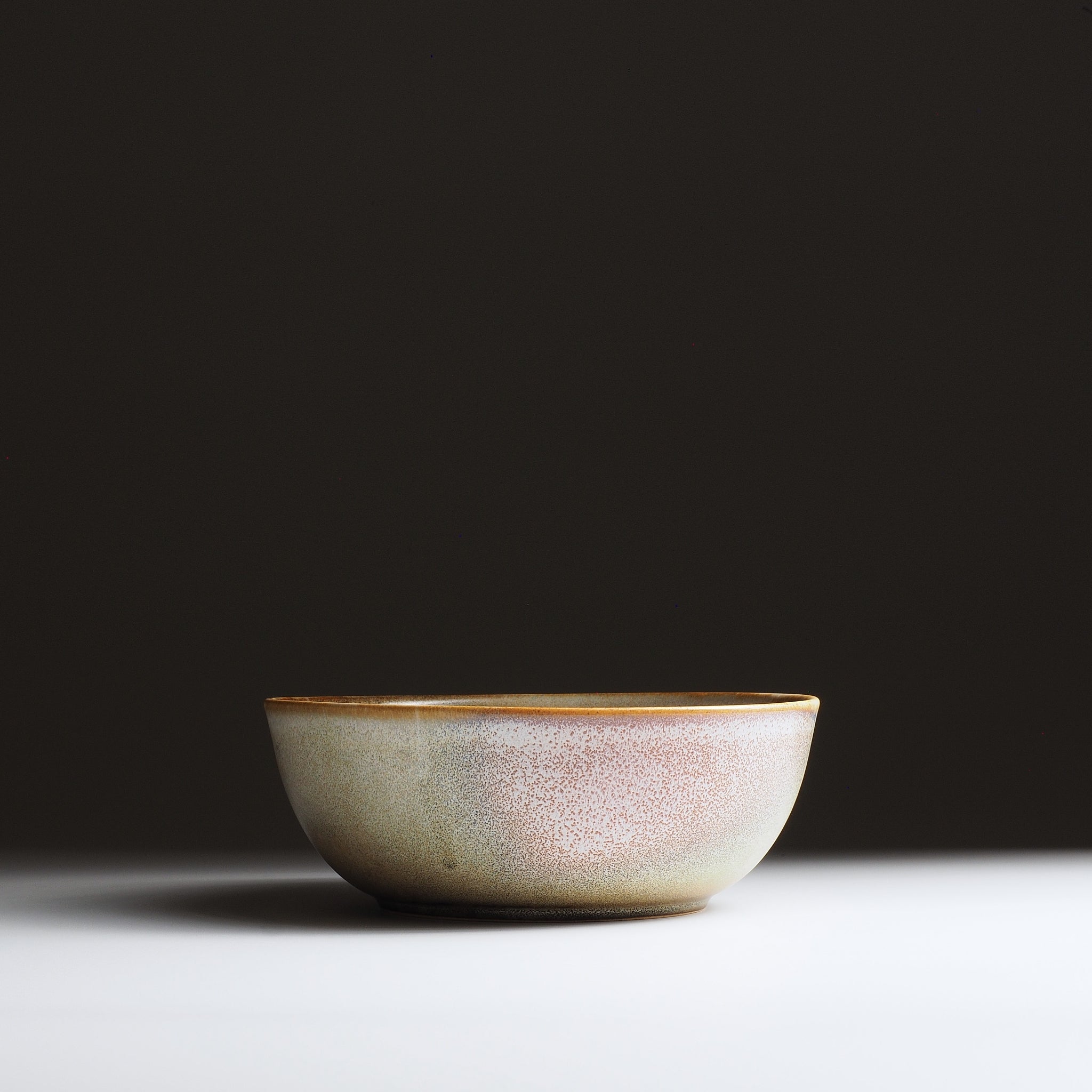 Full frontal view of the Harukaze Pink Cherry Blossoms salad bowl by Kazuhiro Kojima on gradient background