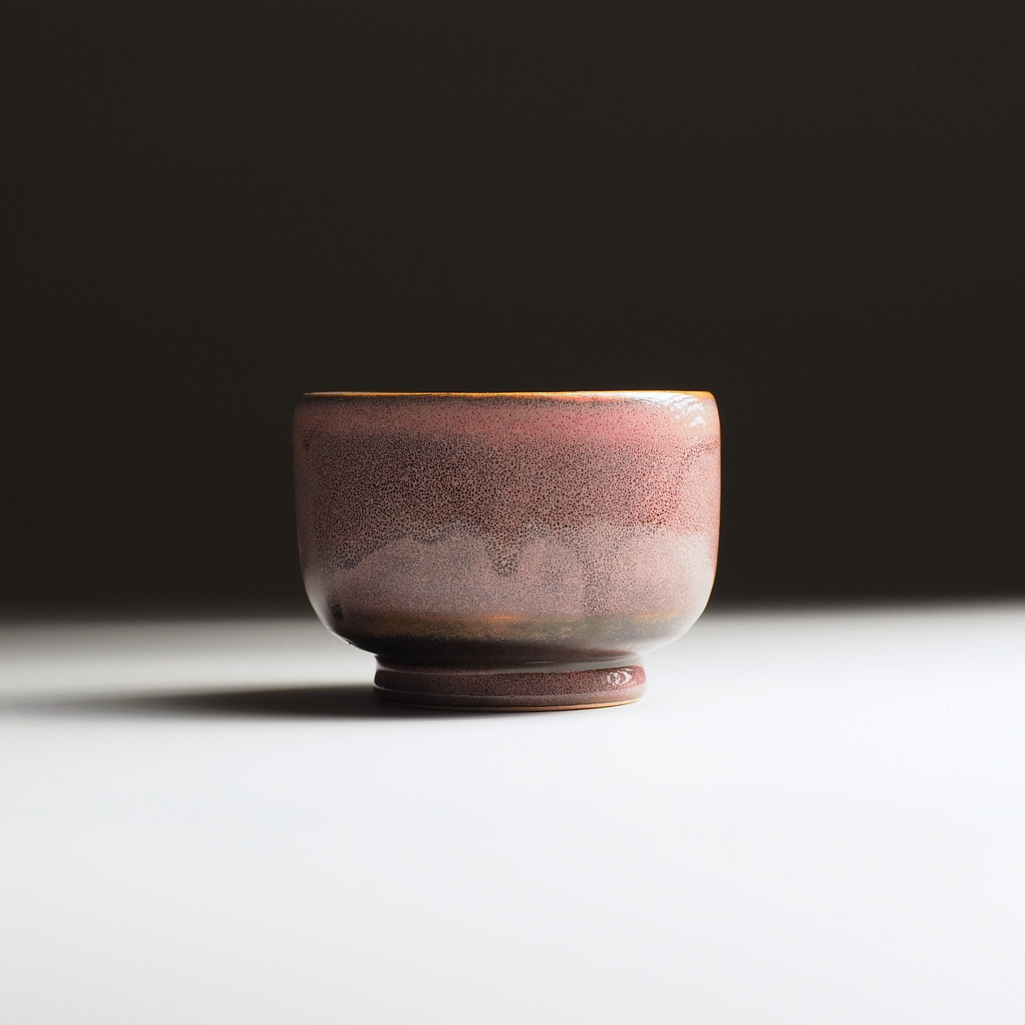 Ceramic cup with a textured surface on a dark background