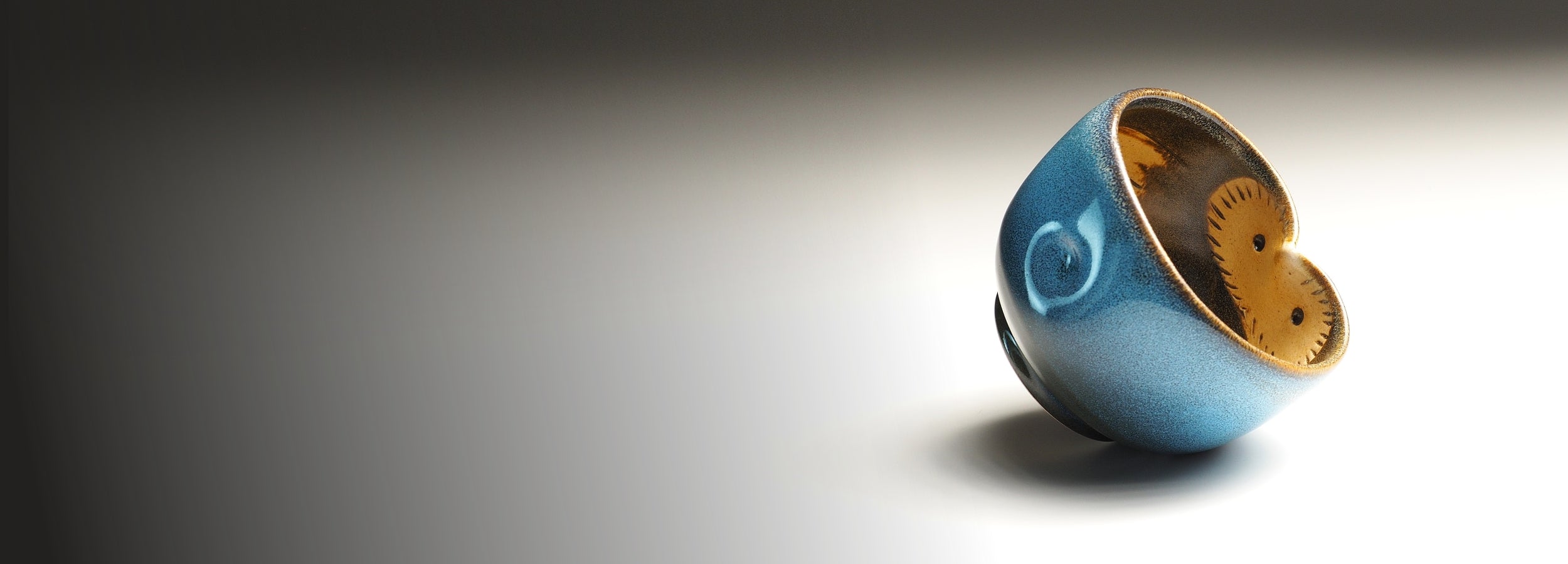 Japanese blue ceramic bowl with a owl design on a gray background