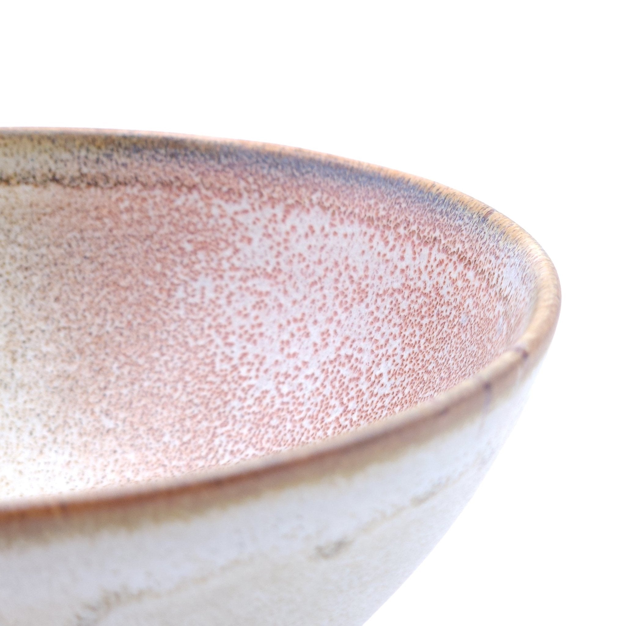 Authentic Japanese pottery bowl with cherry blossoms decoration. Pink and beige color. (side detail view 1).