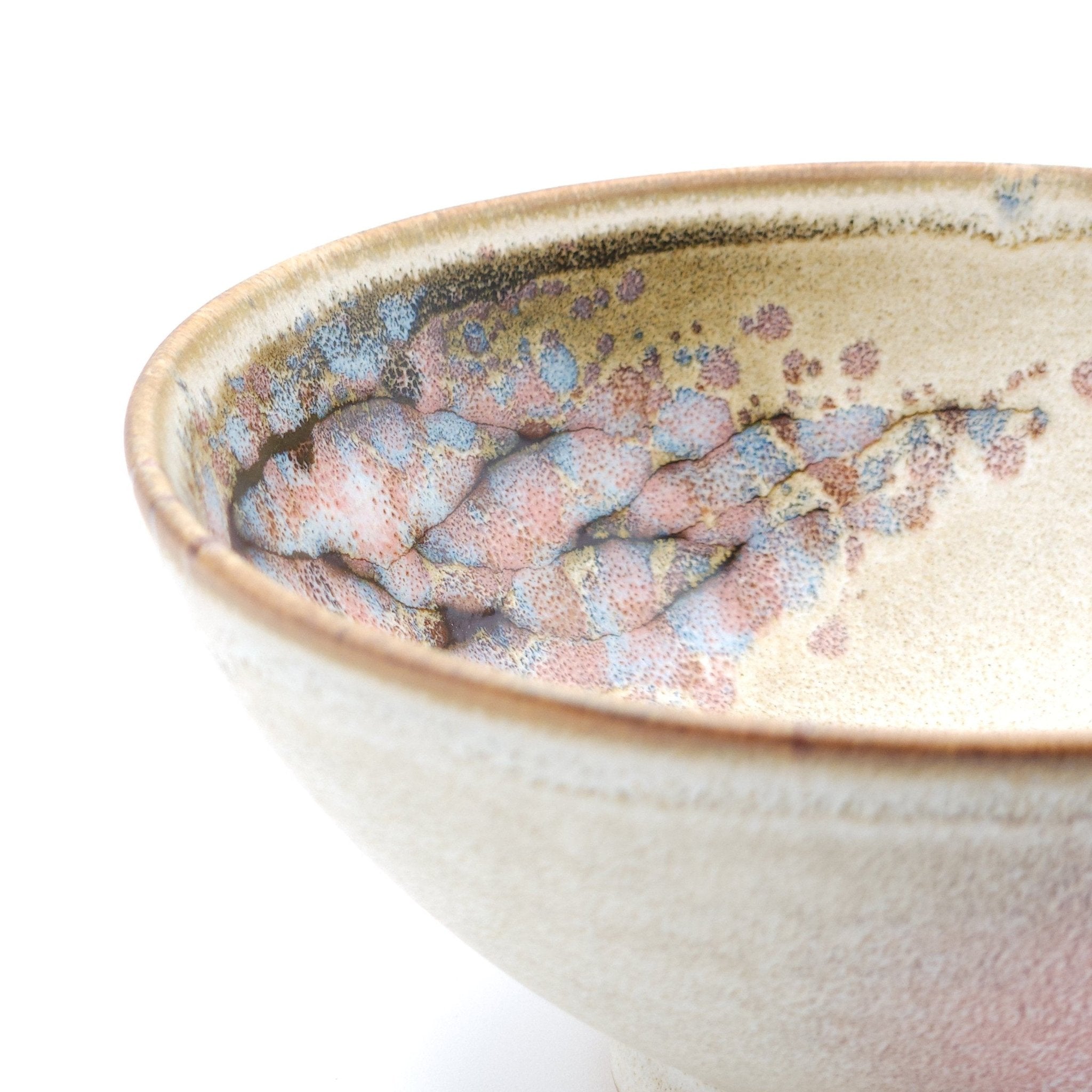 Authentic Japanese pottery bowl with cherry blossoms decoration. Pink and beige color. (side detail view 2).