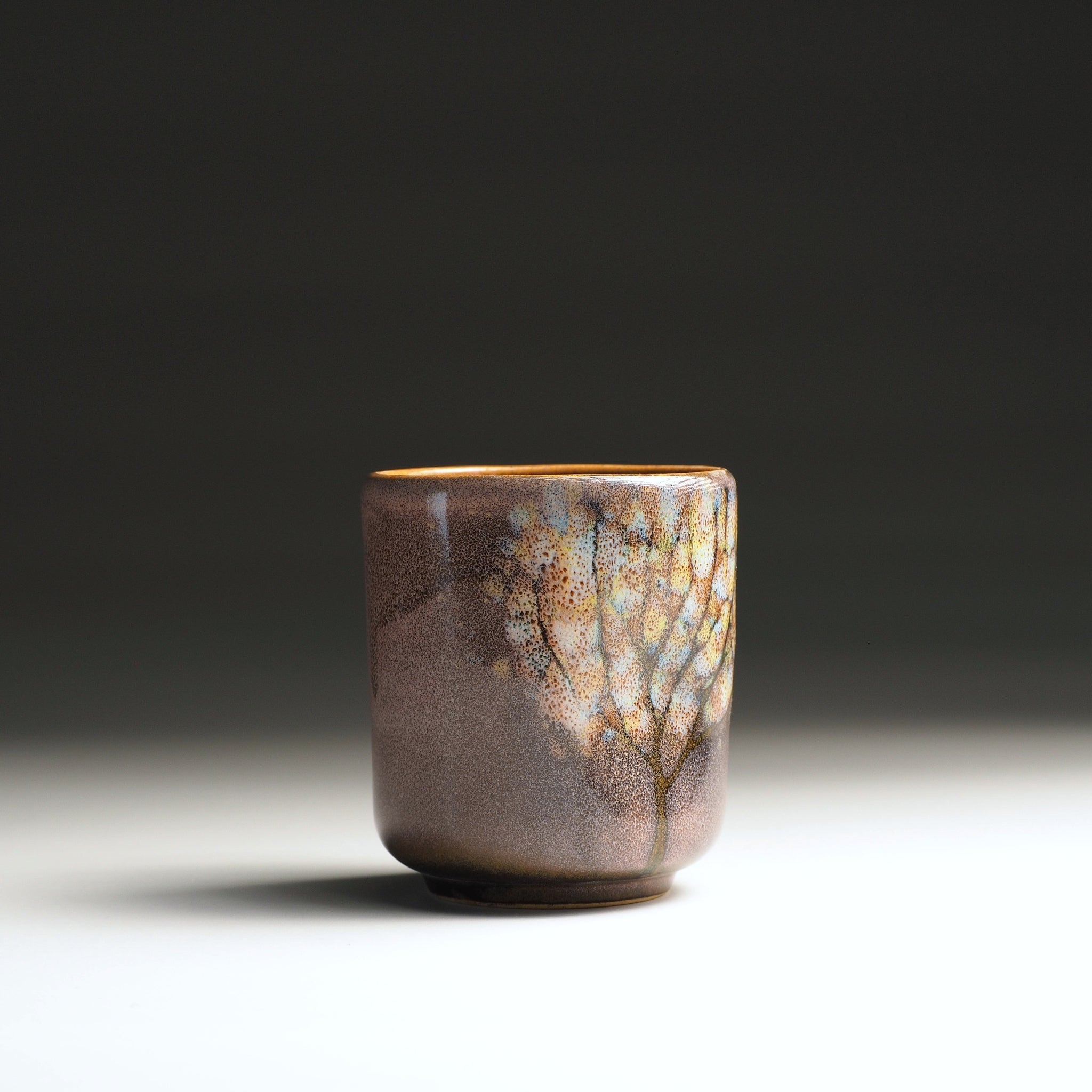 Front view of a handmade Japanese  teacup with wabi-sabi pink-brown glaze, Tsukushi