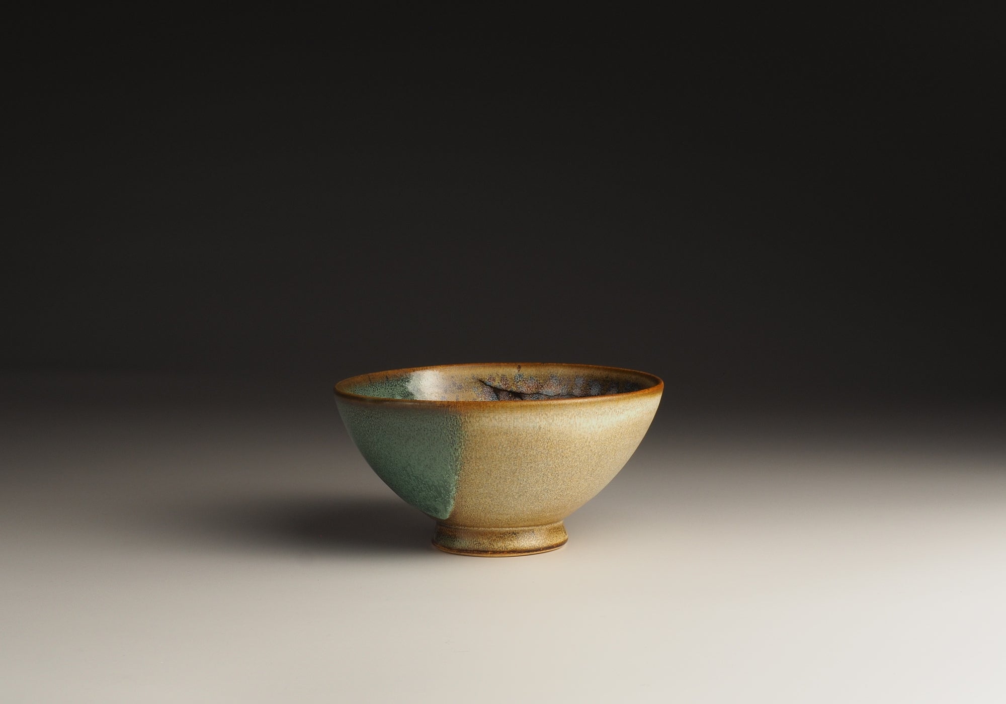 A Japanese ceramic bowl with cherry blossoms pattern on a gradient background. Tsukushi