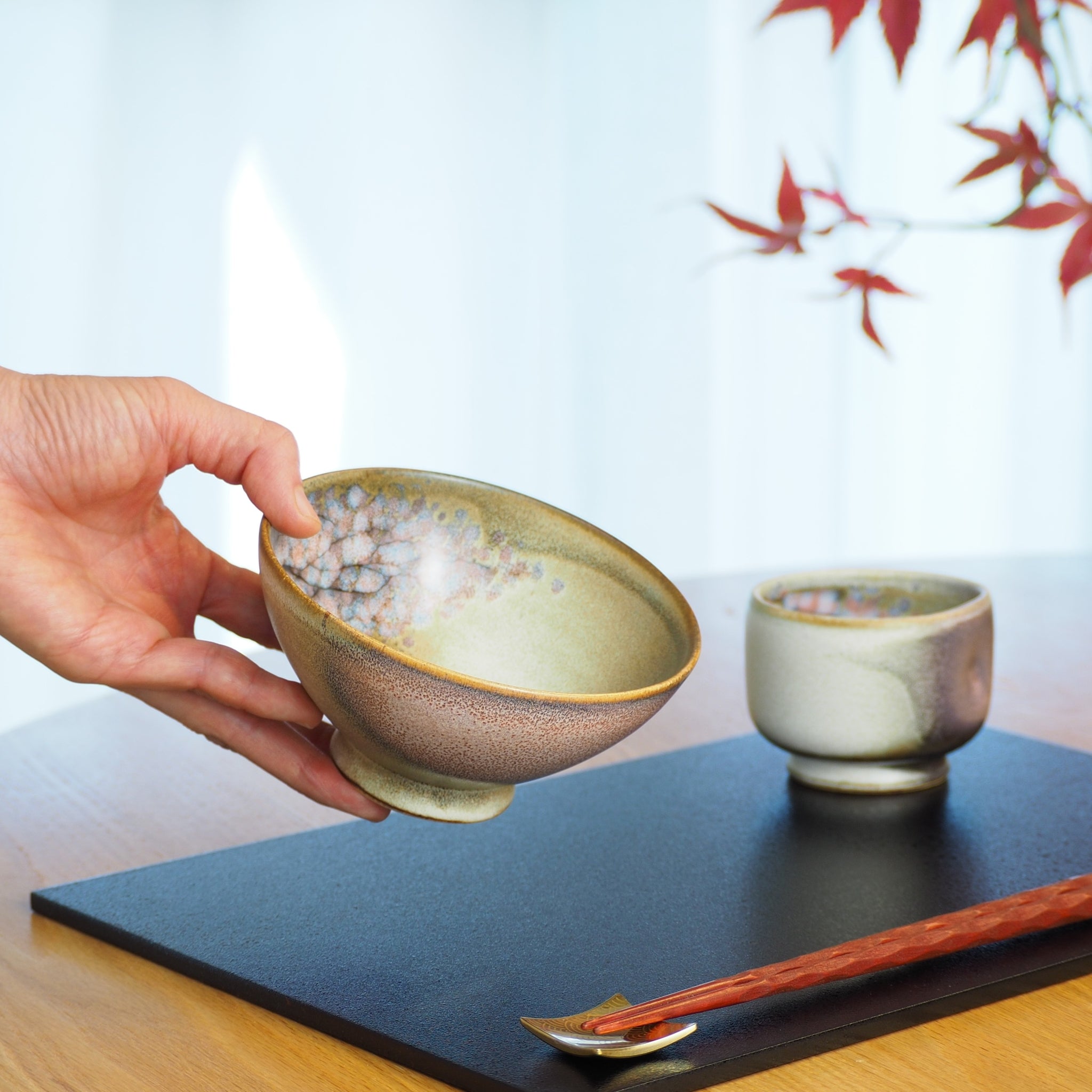 A Japanese handcrafted ceramic sakura rice bowl and tea cup. Tsukushi
