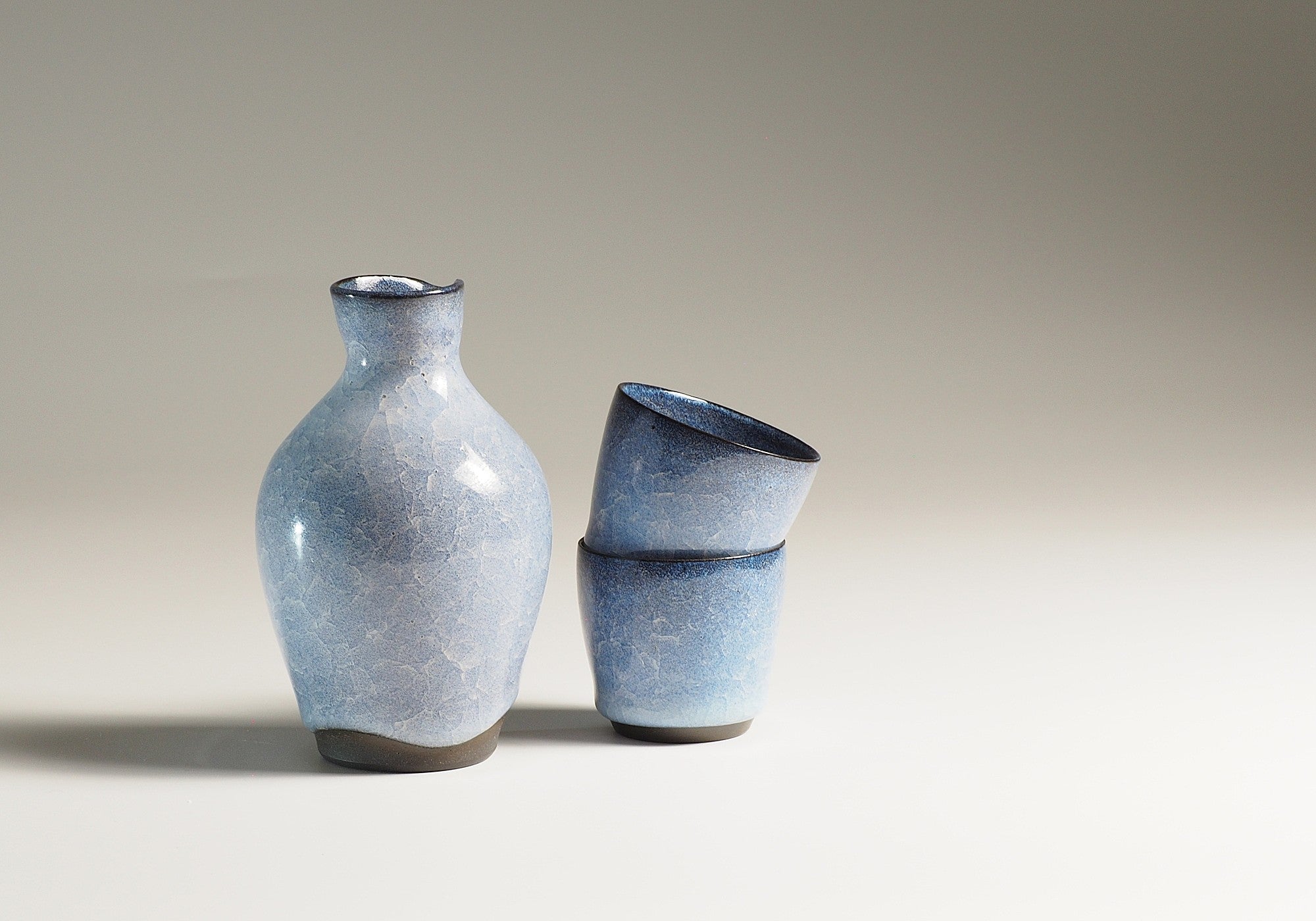 Handmade Japanese pottery crazed design  Tokkuri and Sake cups beige background, Tsukushi