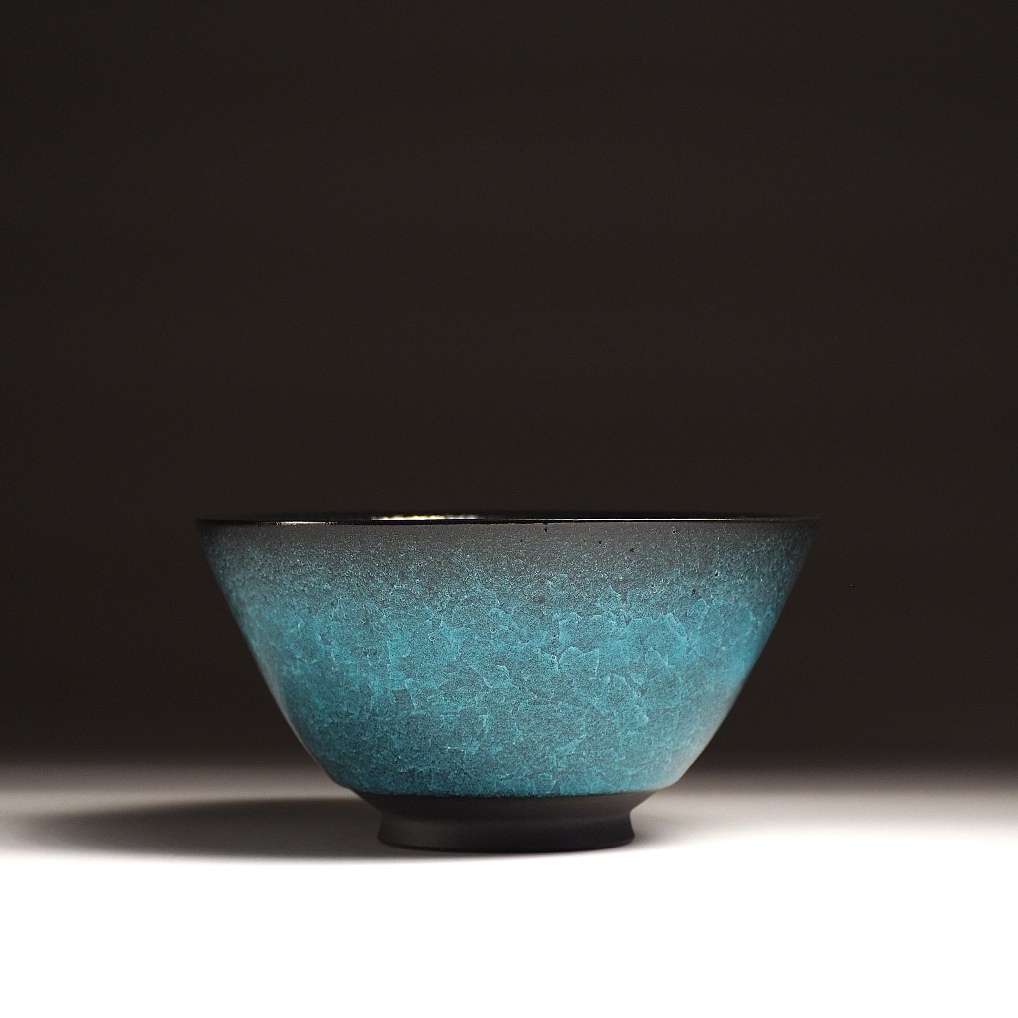 Japanese Emerald green ramen bowl bowl on a dark background. Hero view