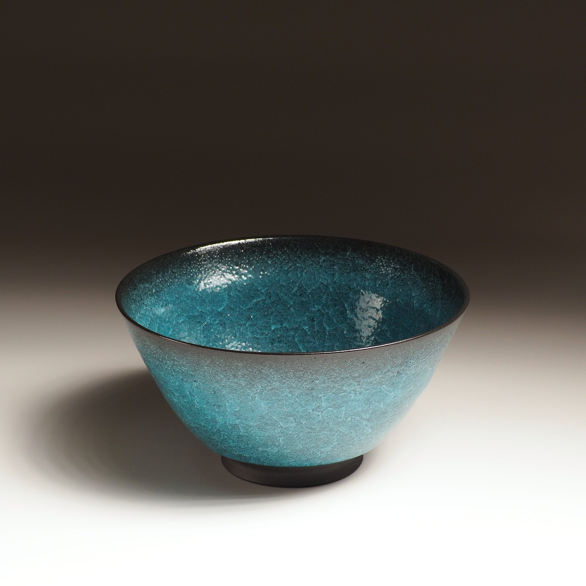 Japanese Emerald green ramen bowl bowl on a dark background. Front-top view