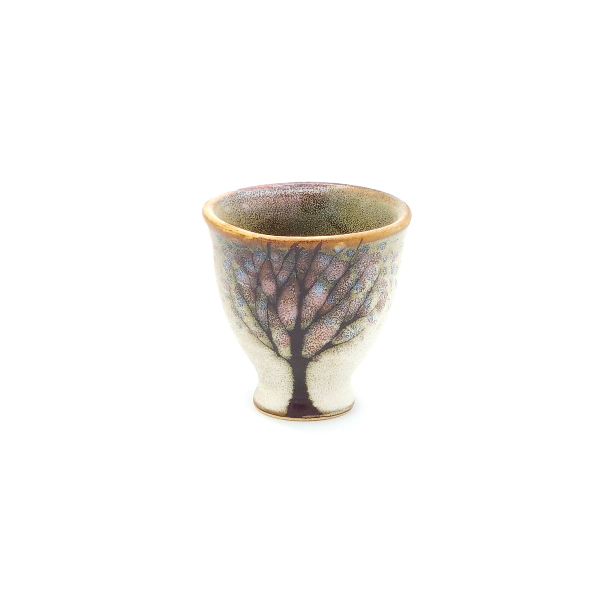 A front view of a Japanese ceramic Conical Sake cup with a cherry blossom pattern. Tsukushi