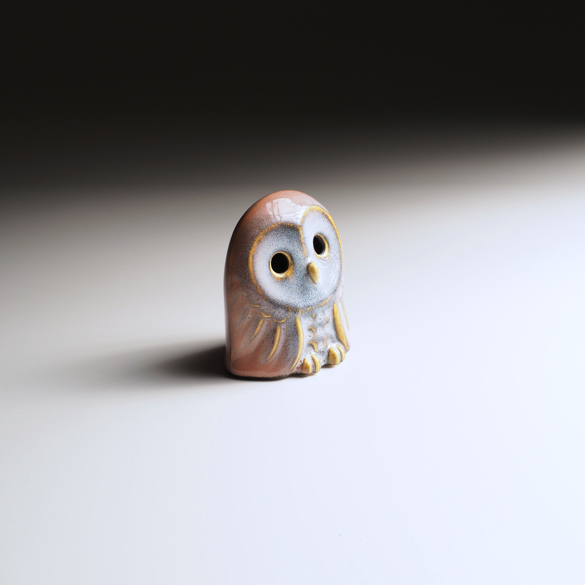 Engifuku ceramic owl figurine on a gradient background