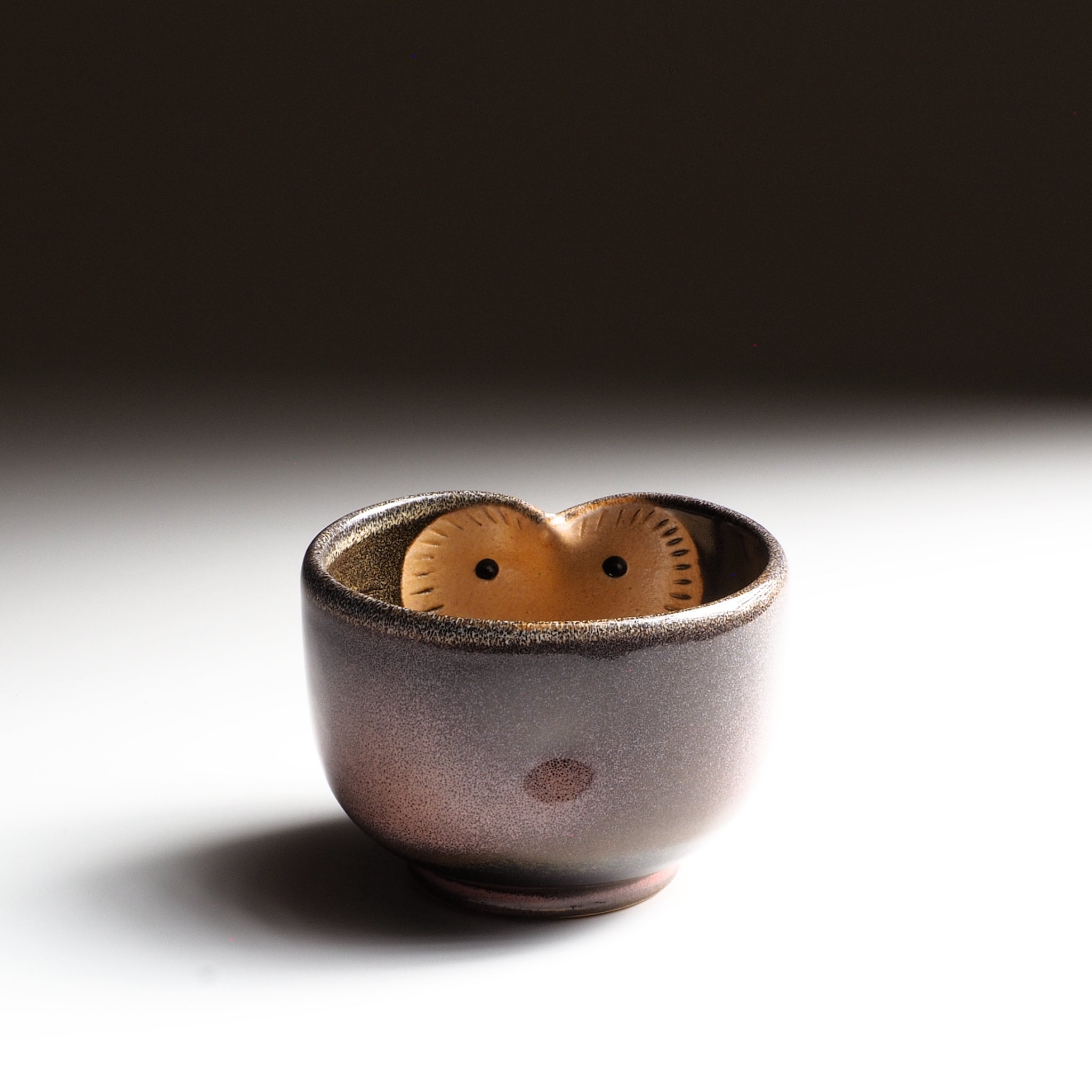 Fukuro pink ceramic yumoni with owl motif inside on a dark background