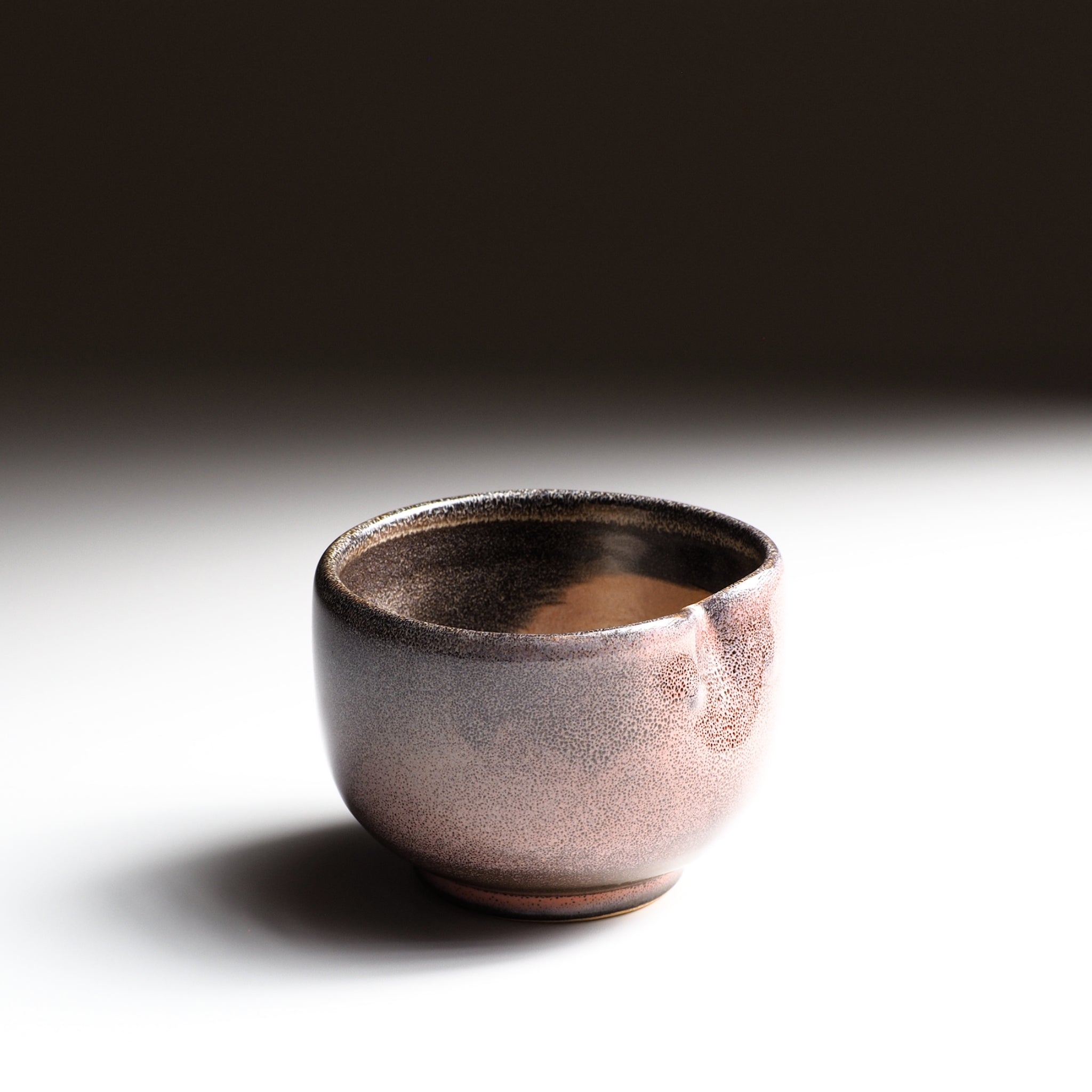 Japanese ceramic teacup Fukuro with a textured surface on a gradient background