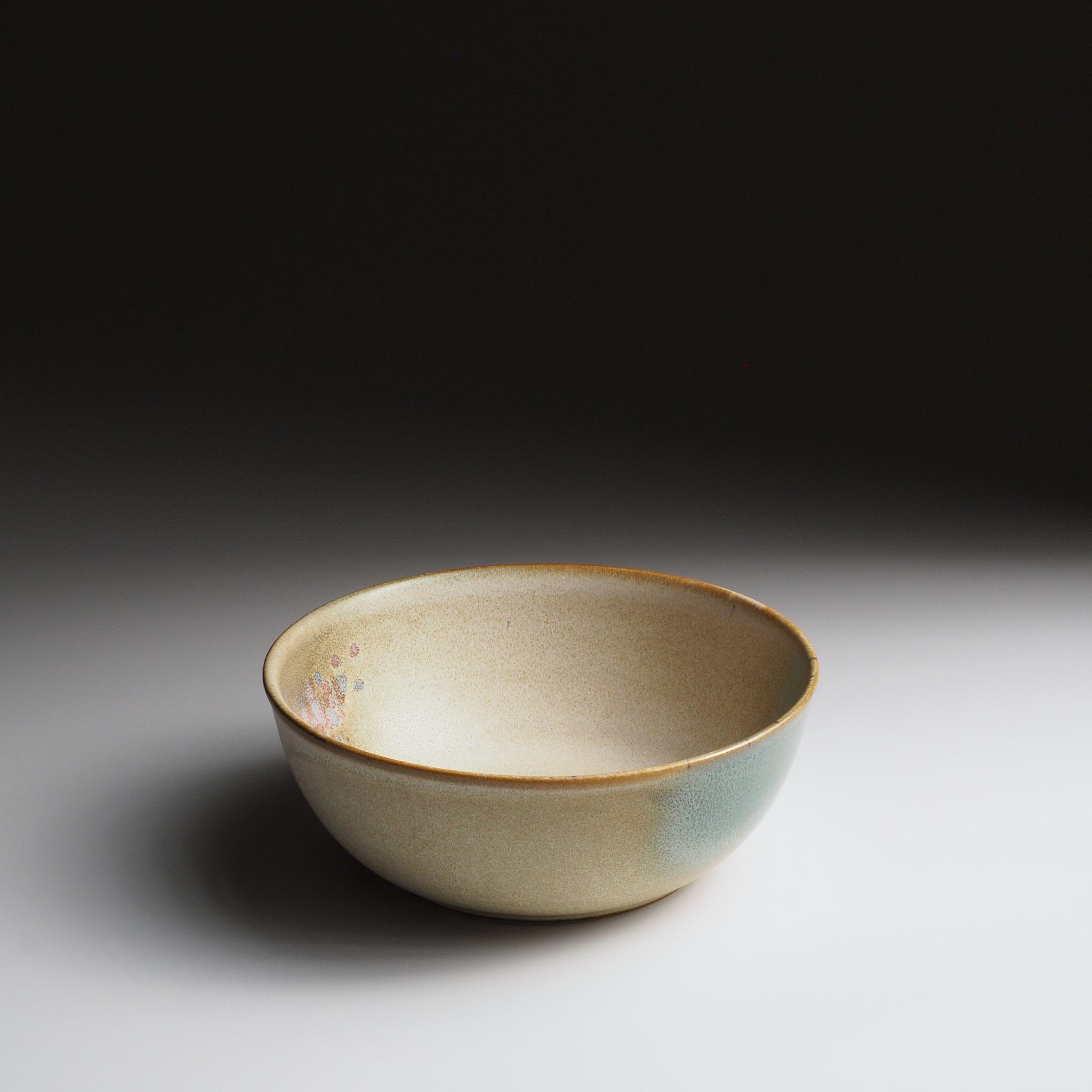 Harukaze Japanese Salad green bowl by artist Kazuhiro Kojima, 3/4 front view on faded background.