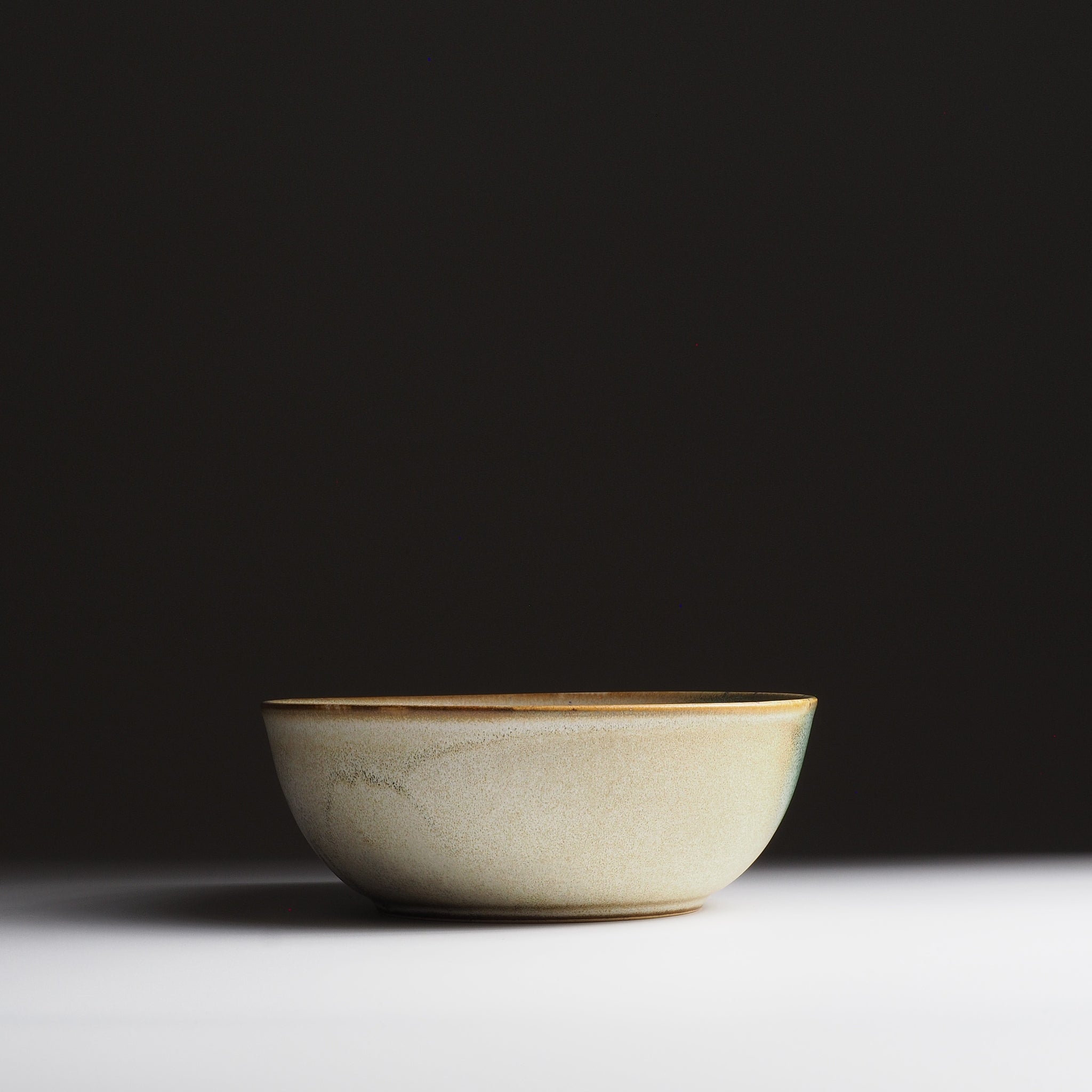 Front view of the Harukaze salad Bowl by K.Kojima, featuring nanasai tenmoku glaze. 
