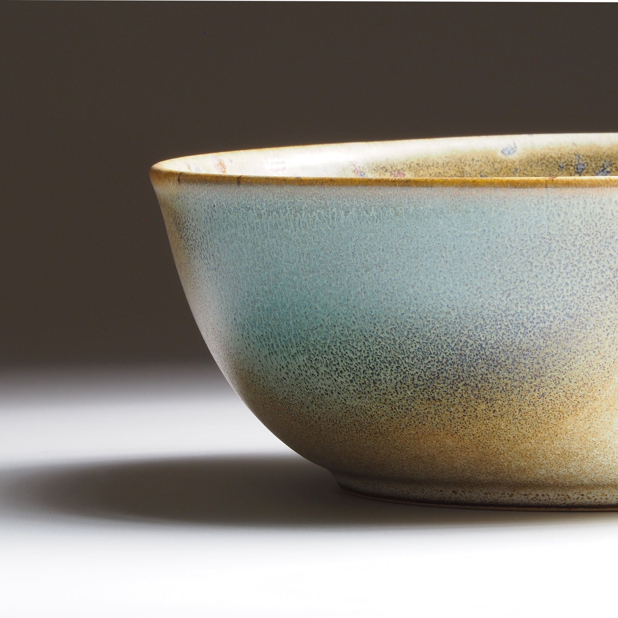 Harukaze Japanese green salad bowl by K.Kojima. Close-up view on gradient background.