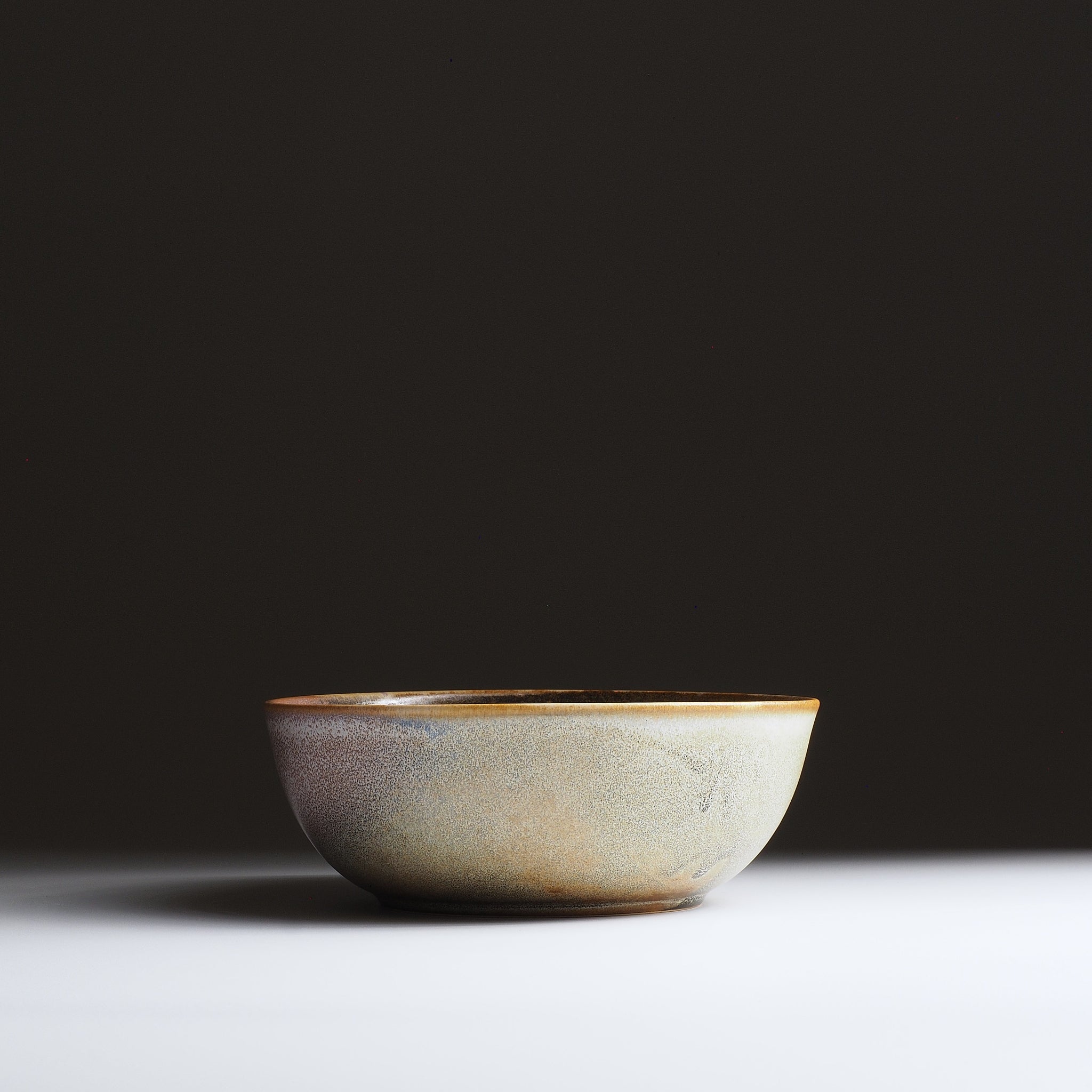 Harukaze Pink Cherry Blossoms salad bowl by Kazuhiro Kojima. full frontal view on a faded background.