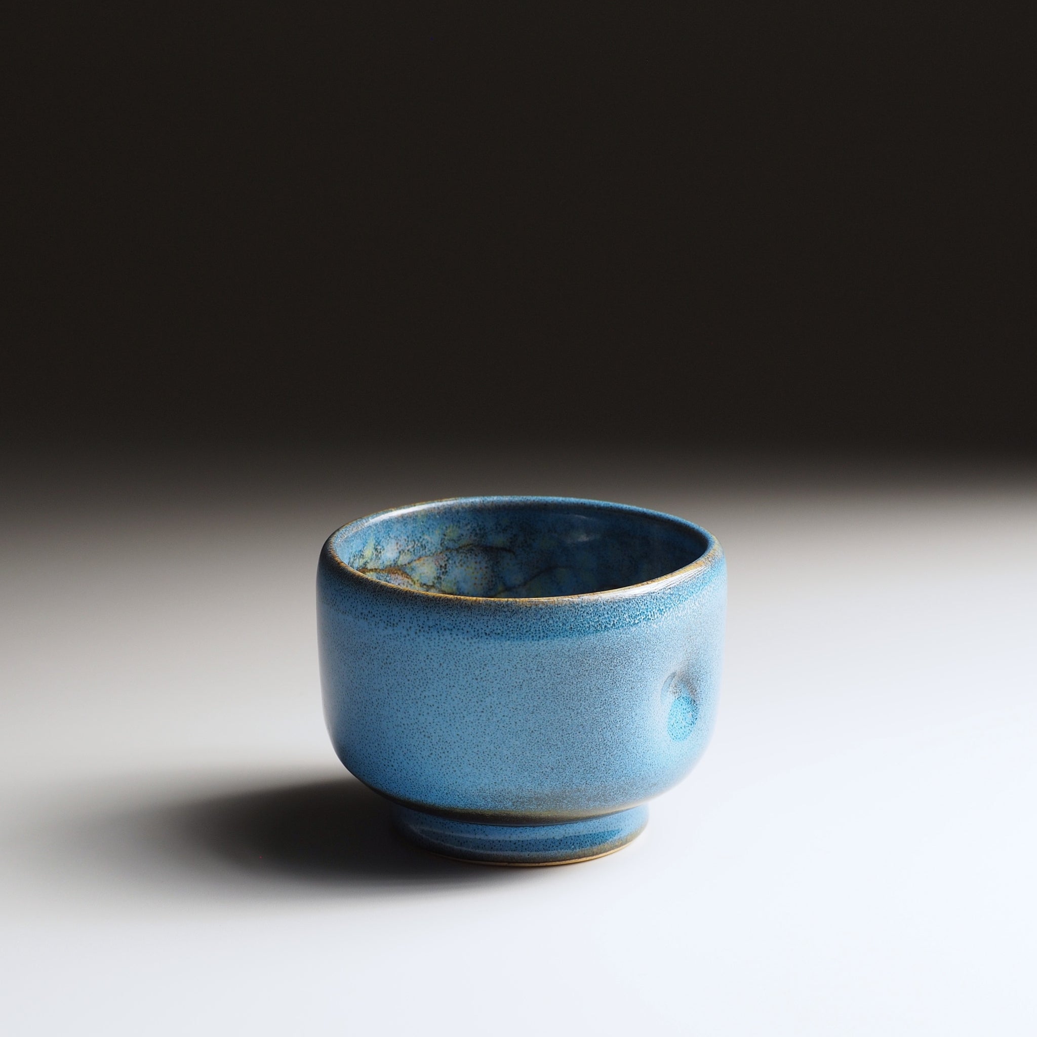 Front view of the Maru Komorebi Yunomi blue teacup by master potter Kazuhiro Kojima of Nunobiki Pottery.