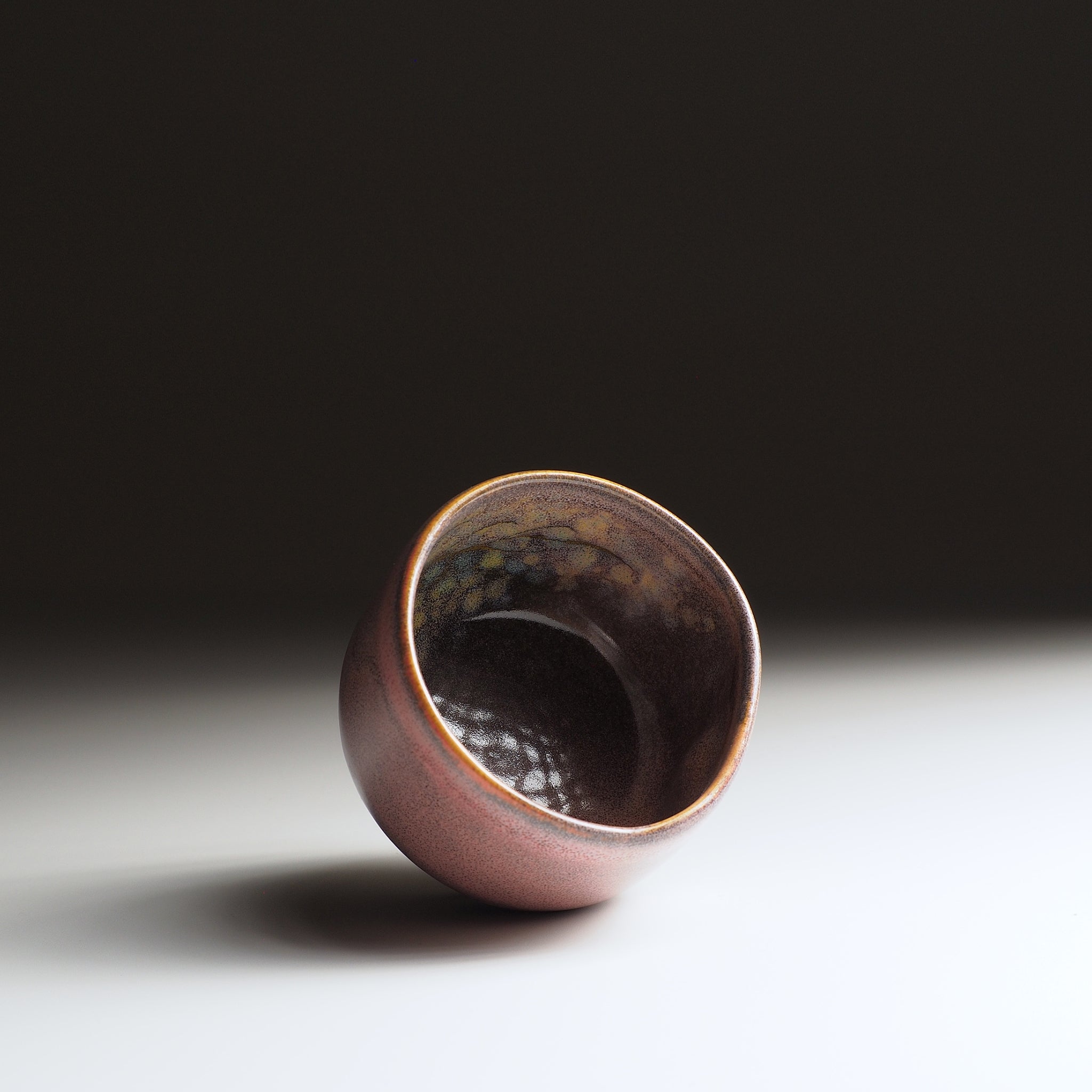 Japanese ceramic teacup with a glossy finish on a gradient background