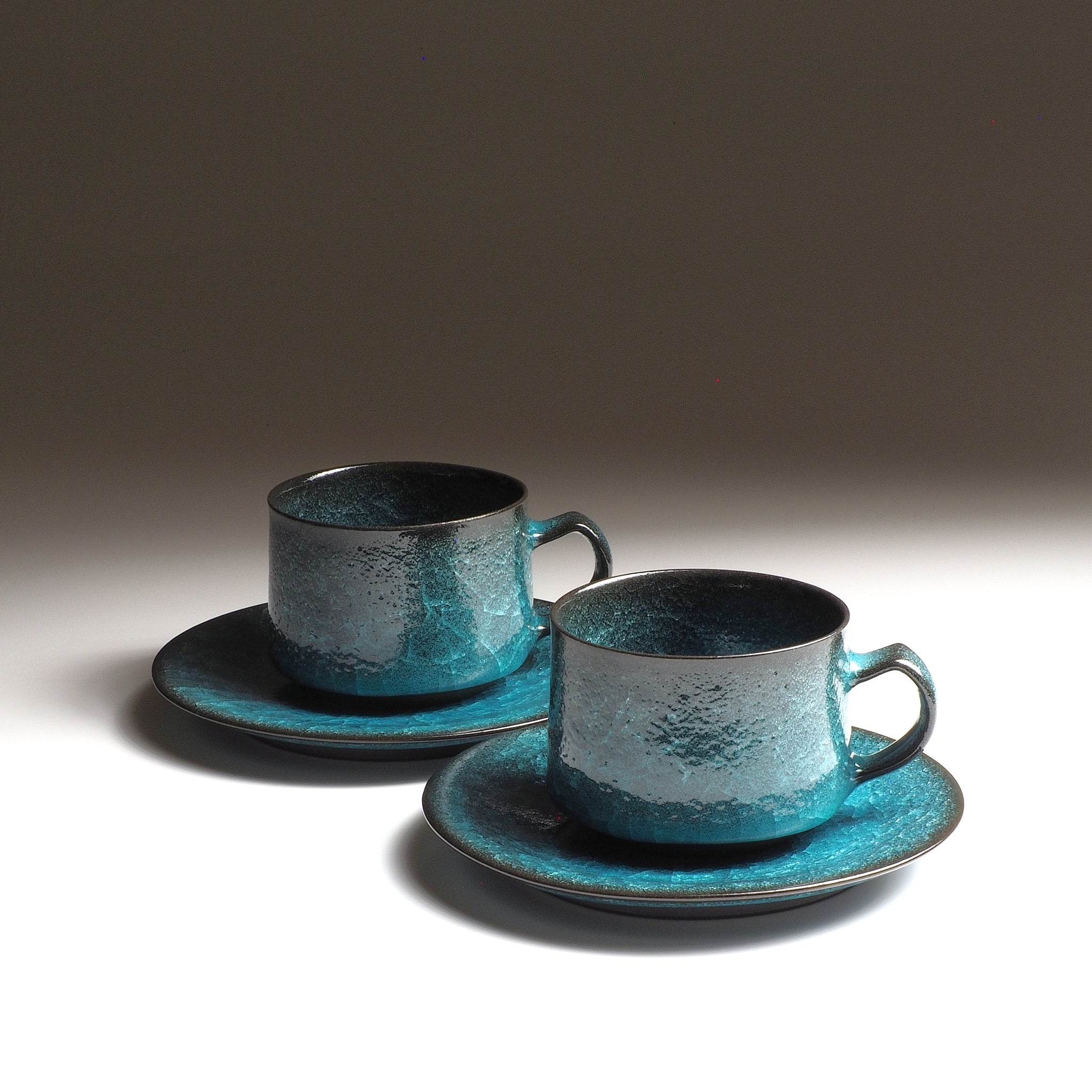 Handcrafted Japanese ceramic coffee cup set with kannyū crackle glaze in emerald green and deep obsidian, by Taichi Kawai, Usurai Pottery Kyoto
