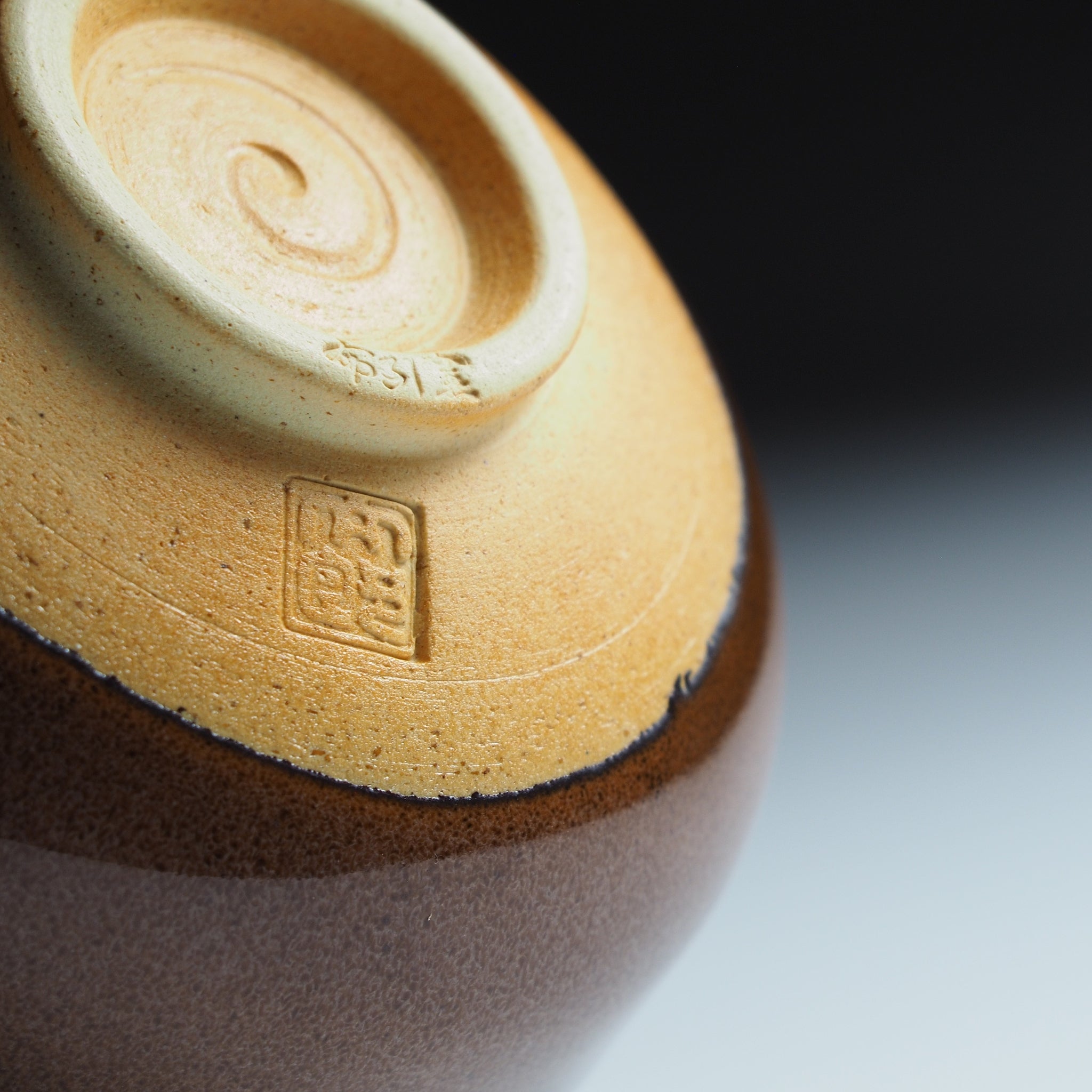Close-up of Yūkaede matcha bowl foot ring, Taro Kojima's impressed seal on natural Shigaraki clay.