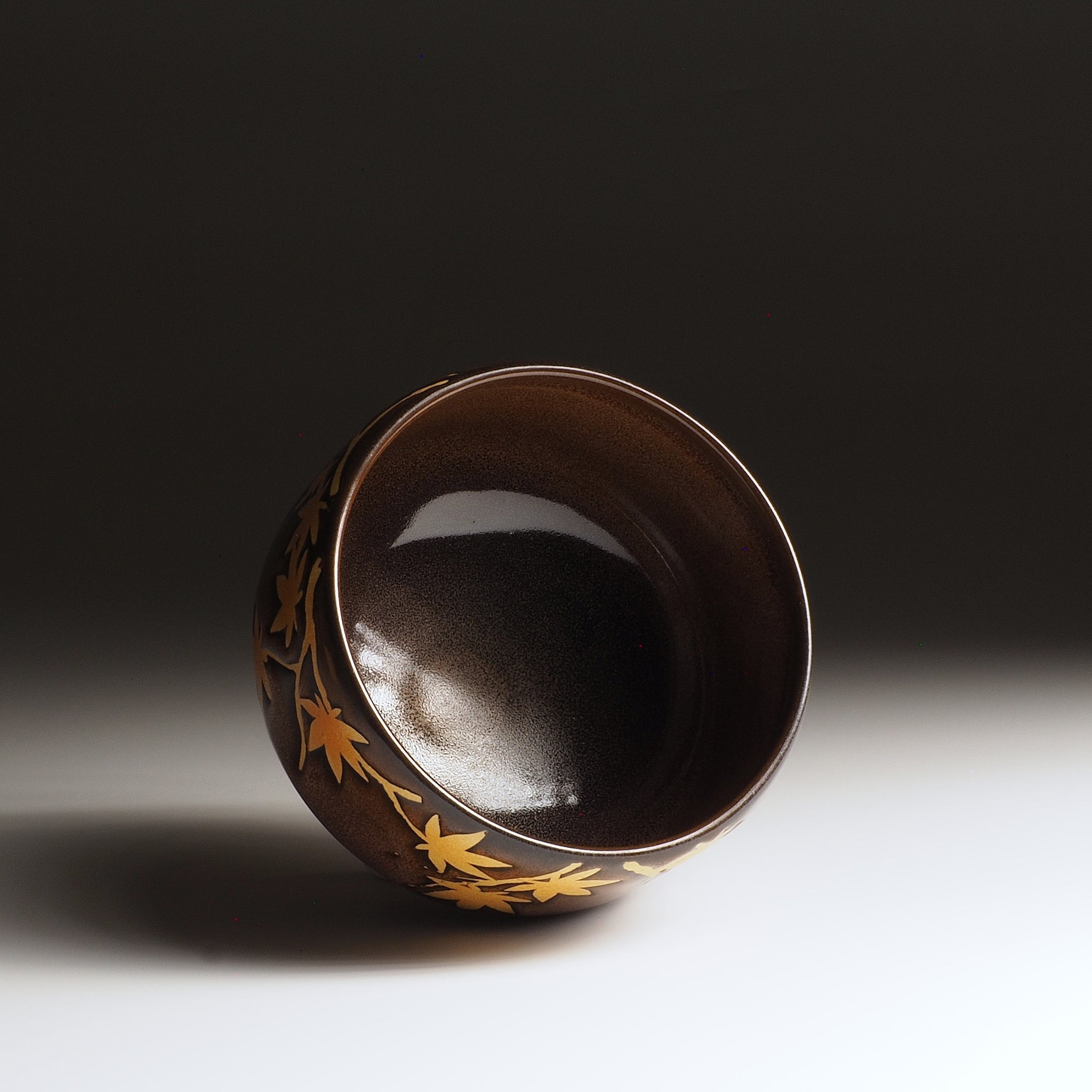 Interior view of Yūkaede matcha bowl, deep Nanasai Tenmoku glaze with momiji decoration on outer wall, Nunobiki Kiln